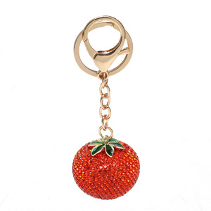 Meilleure vente : Boutons de manchette de luxe léger entièrement ornés de strass, motif kaki, pour filles, avec pendentif porte-clés de sac de voiture en forme de fruit, sensation haut de gamme, style sportif - Product Image 1