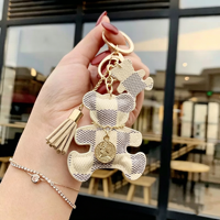 Nouveau porte-clés mignon en forme d'ours, en cuir PU, avec pompon, mini breloque tendance, forme irrégulière, cadeau d'affaires, souvenir, pendentif pour sac de fille