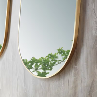 Miroir mural en verre avec cadre en aluminium de forme ovale au design de luxe Miroir de courtoisie mural désembué à commande tactile avec lumière LED