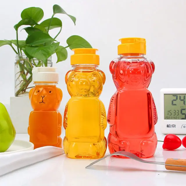 Großhandel niedliche Bärenform Kunststoff-Saftflasche Lebensmittelqualität PET leere Bärenform Getränkeflasche mit Kappen