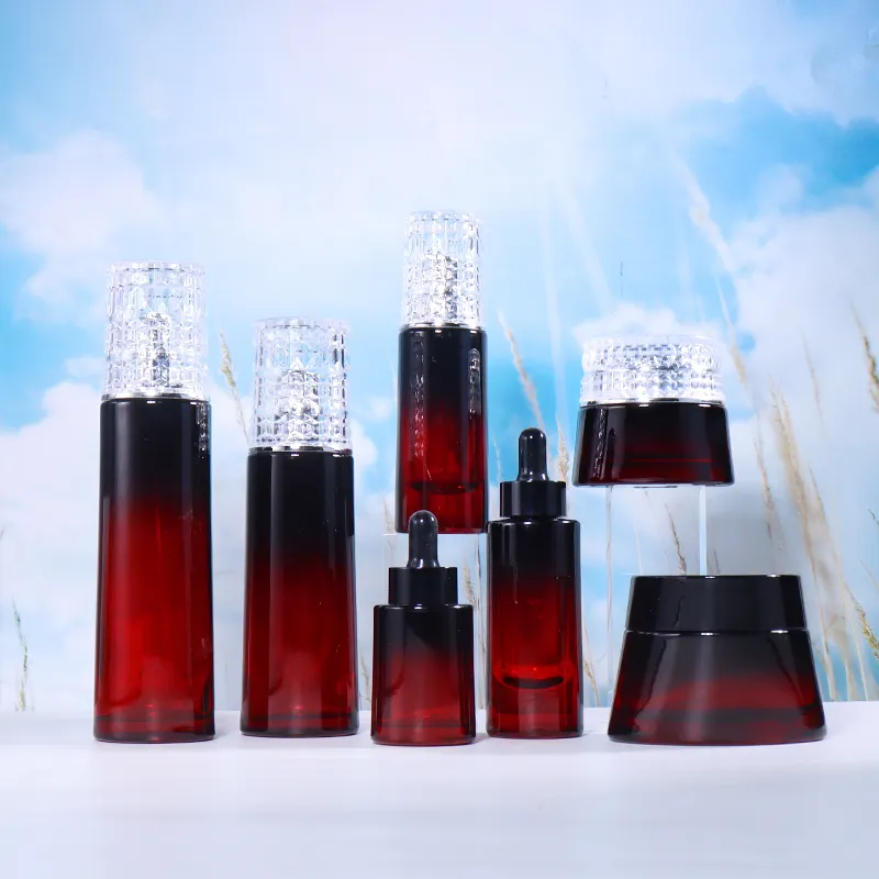 Schwarze und rote Glasflaschen mit Verlauf für Kosmetik Hautpflege Emulsion Ätherisches Öl Sahne leere Gefäße