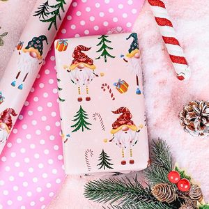 Papel de regalo de Navidad de doble cara rosa con diseño de gnomos de patas largas, bastones navideños y caramelos, en papel estampado. - Product Image 2