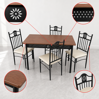 Table à manger rectangulaire avec 4 chaises rembourrées, cadre en métal noir ajouré et sculpté pour cuisine et salle à manger