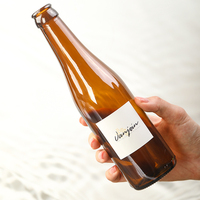 Botella de Vidrio Redonda Marrón Semitransparente de 250 ml y 550 ml para Vino, Bebidas y Cerveza, con Tapa Corona y Logotipo Personalizado