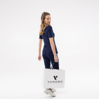 Uniformes médicaux pour femmes YUHONG, col en tissu tissé, coupe régulière, grande taille, style asymétrique personnalisé, pour usage hospitalier