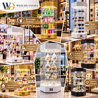 Vitrine rotative sur pied en acrylique transparent à deux niveaux avec éclairage LED pour cosmétiques, parfums, lunettes et modèles dentaires