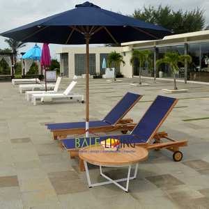 La table ronde Cattalina présente une base robuste en aluminium, un bois de teck élégant et des accents en fer, idéale pour les espaces extérieurs dans les villas. - Product Image 3