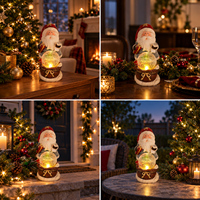Figurine de Père Noël en résine tenant une boîte cadeau et une liste de souhaits avec boule de cristal lumineuse sur base de neige, décorations de Noël