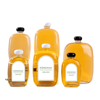 Vente en gros de flacons en verre transparent élégants à bille roulante de 350 ml et 500 ml pour jus pressé à froid avec bouchon à vis noir
