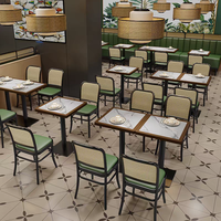 Ensemble de table et chaises de restaurant et bistro moderne avec dossier en rotin tressé et structure en métal, table avec plateau en pierre pour la salle à manger