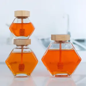 Tarro de almacenamiento de abeja de miel de vidrio con forma hexagonal 180ml 220ml 380Ml con varilla agitadora de tapa de madera