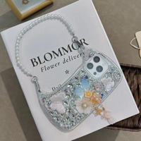 Coque de téléphone de luxe antichoc pour femme avec dragonne diamantée, strass, papillon, perle et fleur pour iPhone 13/14/15/16/17