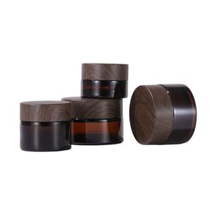 Vente en gros de pots à crème pour le visage en ambre de 5g, 10g, 15g, 20g, 30g, 50g, avec couvercles en plastique imitation bois et contenants en verre - Product Image 1