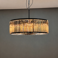 Lampe suspendue circulaire de luxe en cristal avec cadre en fer noir et chaîne réglable pour l'éclairage domestique de la salle à manger