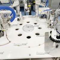 Machine automatique de remplissage et de bouchage de flacons à bille roulante, type chuck, pour déodorant et huiles essentielles