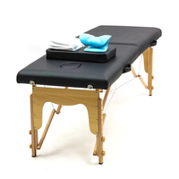 Table de massage thaïlandaise pliable portable en promotion, design moderne, cuir noir, pieds en bois, pour salon, cils, lit de massage, usage hôtelier