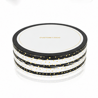 Caja Redonda Negra de Cartón Reciclable Personalizada con Tapa Blanca y Logotipo Estampado con Puntos Dorados para Empaque de Cosméticos