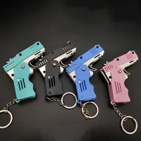 Legierung Kunststoff platte Gummiband Pistole Schlüssel bund Farbe 6-Schuss Mini Gummiband Pistole Kinderspiel zeug Pistole