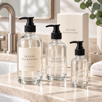 Bouteilles distributrices de savon liquide en verre transparent Boston rondes de 250 ml, 500 ml, 1000 ml avec pompes à lotion noires, logo personnalisé et emballage en boîte