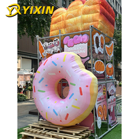 Décoration publicitaire personnalisée pour festival en plein air : toile de fond photo géante gonflable en forme de beignet en PVC imperméable avec dessin animé intégré