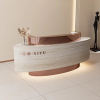 Bureau de réception de salon de beauté de forme ovale au design de luxe avec Led Bureau de réception moderne en acier inoxydable noir blanc pour le bureau