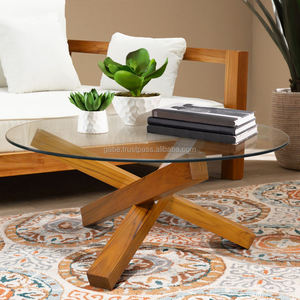 Elegante mesa de centro redonda con patas cruzadas de madera de teca maciza y una elegante superficie de vidrio, que combina durabilidad con un diseño moderno. - Product Image 2