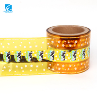 Rollo de película flexible brillante de calidad alimentaria con impresión personalizada para envolver chocolate, piruletas y caramelos duros con alta retención de torsión