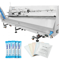Machine d'agencement de sachets pour masques cosmétiques, sachets échantillons, avec orienteur de direction, retourneur de surface, ligne de tri et d'emballage