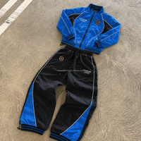 Ensemble de survêtement personnalisé pour homme, bleu et noir, avec col montant, passepoil contrastant et design à panneaux, usine OEM ODM