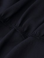 Robe midi décontractée et élégante pour femme, nouvelle collection 2026, avec décoration laminée et col suspendu, style rétro chic sans manches.