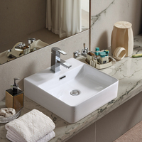 Lavabo de salle de bain moderne en céramique blanche polie avec meuble sous-évier et lavabo artistique intégré au comptoir