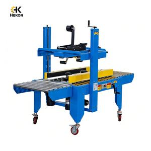 เครื่องปิดกล่องกึ่งอัตโนมัติแบบขับเคลื่อนด้านข้าง HEKON เครื่องปิดกล่อง เครื่องปิดเทปกาวกล่อง เครื่องซีลกล่อง - Product Image 1