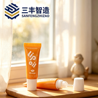 Tube cosmétique en LDPE orange brillant avec applicateur à bille et bouchon à vis pour huile à lèvres