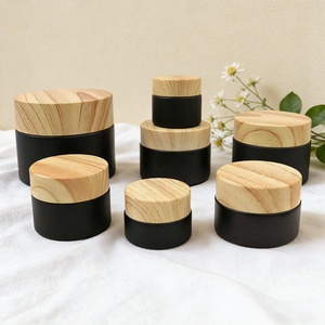 ขวดสีดำด้านขนาด 5 กรัม 10 กรัม 15 กรัม 20 กรัม 30 กรัม 50 กรัม 100 กรัม สำหรับบรรจุภัณฑ์เครื่องสำอาง ขวดครีมแก้วพร้อมฝาพลาสติกลายไม้ - Product Image 1