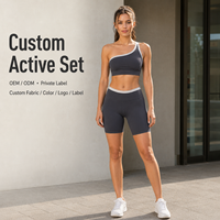 Conjunto de ropa deportiva al por mayor para mujer: Sujetador deportivo de un solo hombro y shorts de ciclista de cintura alta con ribete en contraste para entrenamiento.