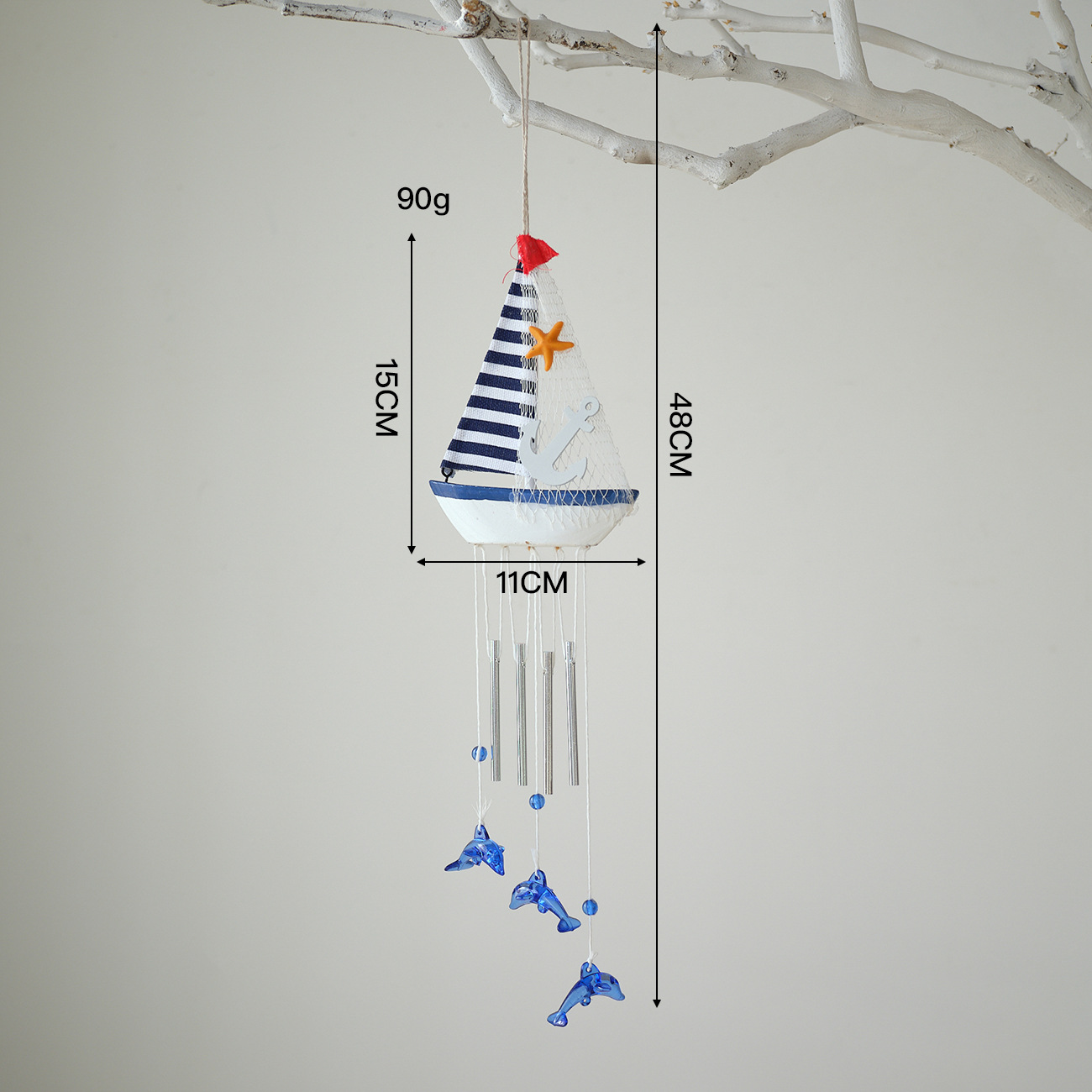 Blue and white wind chimes in blue fabric
