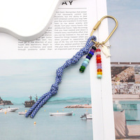 Nouveau porte-clés en métal avec corde tressée colorée, décoration perlée faite à la main, pendentif anti-perte pour sac à dos et clés de voiture