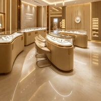 Solution de mobilier sur mesure pour bijouterie : Vitrine îlot incurvée, présentoir mural, finition or champagne, éclairage LED