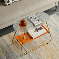 Table basse ovale moderne et durable à double plateau en verre avec structure métallique, design étroit et rangement ouvert pour salon et chambre à coucher