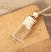 Vente en gros de flacons de parfum pour voiture de luxe, 8 ml, vides, en verre, forme cylindrique, diffuseur de parfum pour voiture suspendu avec couvercle en bois
