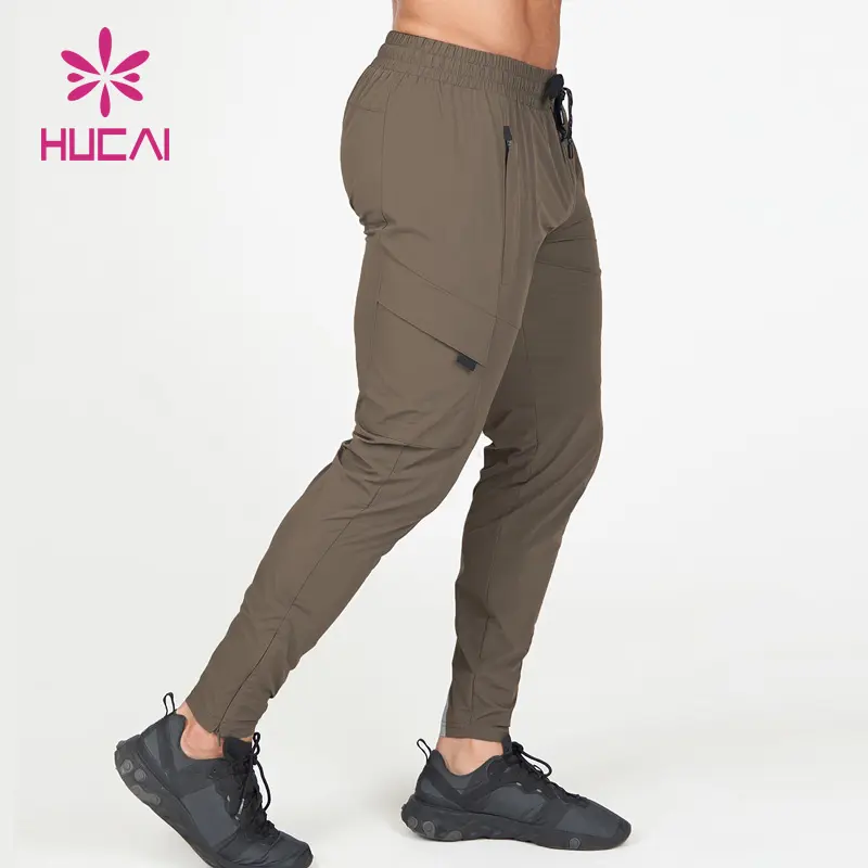 HUCAI Private label slim fit workout polyester skinny fitness custom logo men sweatpants gym mens joggers pockets