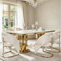 Table à manger moderne de luxe en métal avec plateau en pierre frittée marbrée et pieds en acier inoxydable créatifs pour mobilier de salle à manger d'hôtel