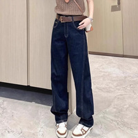 Jeans taille haute pour femme, bleu foncé délavé, coupe incurvée, style urbain, design oversize, ourlet effiloché, vente en gros usine