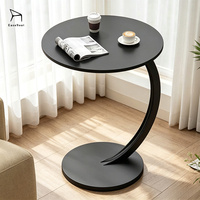 Table à manger ronde robuste et durable au design simple avec pieds en métal en forme de C pour utilisation près du canapé et du lit