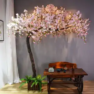 Árbol de fibra de vidrio artificial personalizado para interiores, árbol decorado con arco de flores de cerezo para decoración de tienda