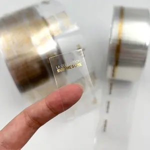 कस्टम लोगो प्रिंट पारदर्शी सोने के स्टीकर लोगो लेबल चिपकने वाला स्पष्ट सोने की पन्नी स्टिकर
