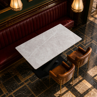 Ensemble de salle à manger Art Déco en marbre blanc, table de restaurant à base en X avec fauteuils en cuir cognac, personnalisable, fournisseur OEM en gros, Chine