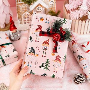 Papel de regalo de Navidad de doble cara rosa con diseño de gnomos de patas largas, bastones navideños y caramelos, en papel estampado. - Product Image 3