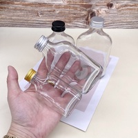 Bouteille en verre transparente vide pour liqueur, bouteille en verre ronde plate pour jus, emballage de bouteille avec logo imprimé personnalisé, vente en gros