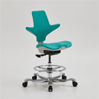 Protecteur orthopédique de colonne vertébrale de selle Chaise d'équitation ergonomique Tabouret de selle d'équitation de dentiste Chaise pivotante roulante Chaises moussantes en PU